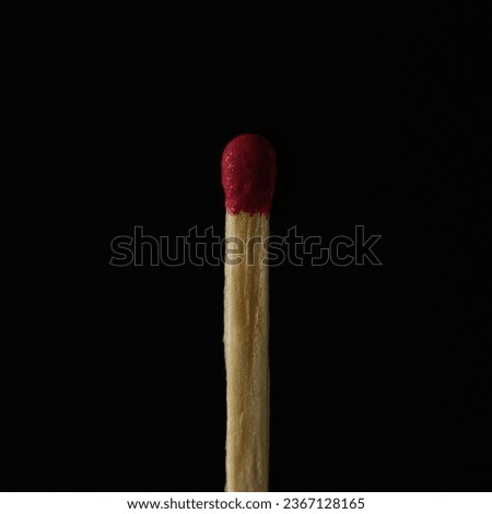 The close-up view of an unlit matchstick before the black background Royalty-Free Stock Photo #2367128165