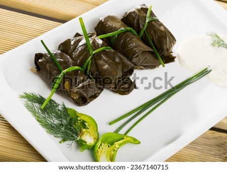 Tasty grape rolls made from grape leaves, dish of Bulgarian cuisine Sarni at plate