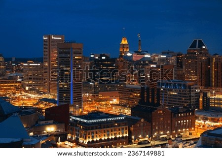 Baltimore inner harbor district rooftop view at night with urban buildings.