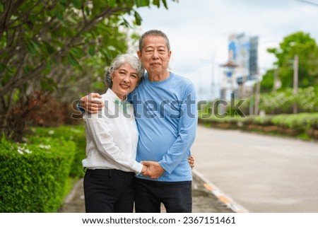Elderly love, couple relaxing outdoors in blissful family time, peaceful moments, Mature asian husband and wife family time in natural serenity, heartwarming, relaxation Royalty-Free Stock Photo #2367151461