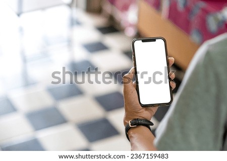 Man looking at the smartphone in his hand