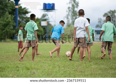 Asian boy having fun playing football