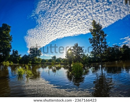 Beautiful clouds, clear sky, cloud shadows on the water, flooding the rice fields, the sky touching the water