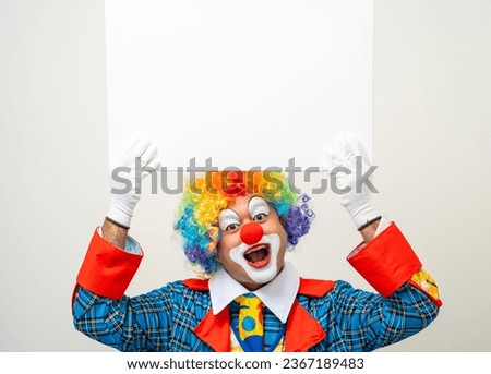 Mr Clown. Portrait of Funny face Clown man in colorful uniform standing holding copy space. Happy expression male bozo in various pose with frame mockup blank space on isolated background.