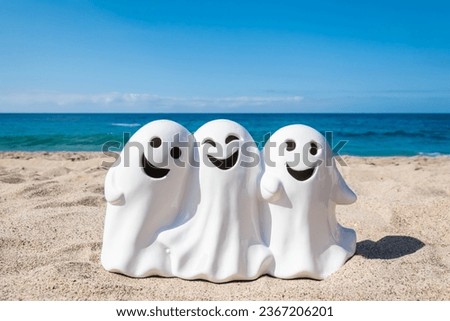 Halloween beach and ocean background with three smiling ghosts