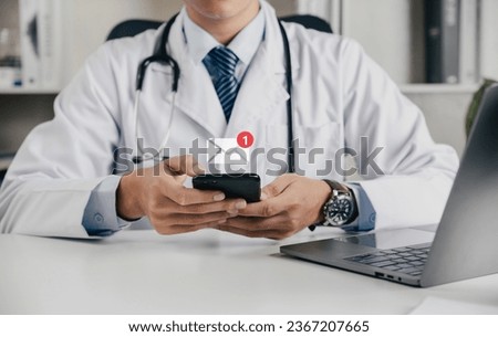 Doctor using smartphone for telemedicine and consult email with notification alert, Online communication concept.