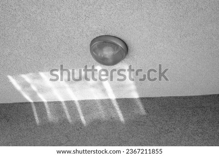 Shine on the wall,ceiling light turned off. Black and white photography.