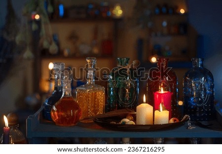 magic potions in  witch's house with burning candles at night Royalty-Free Stock Photo #2367216295