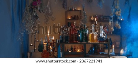 magic potions in  witch's house with burning candles at night Royalty-Free Stock Photo #2367221941