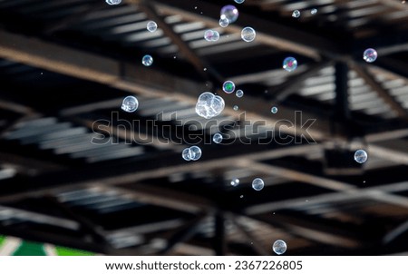 Soap canopies bubbles fly against the background of the roof