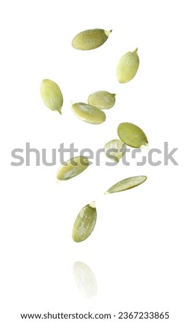 Pumpkin seeds flying in the air isolated on white background. Royalty-Free Stock Photo #2367233865