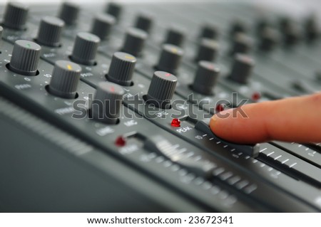 Finger on mixing desk
