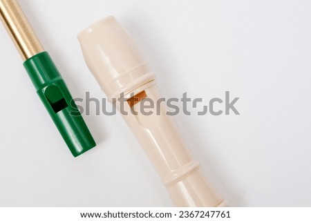 Irish whistle and block flute are longitudinal flutes with a whistle device and playing holes. Royalty-Free Stock Photo #2367247761