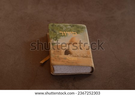 women pointing inside pretty leather Jewish Hebrew prayer book while praying Royalty-Free Stock Photo #2367252303