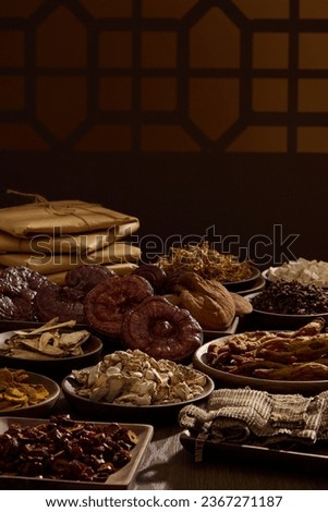 Traditional folk medicines are displayed on wooden trays. Behind are traditional brown window frames and medicine packages. Photography traditional medicine content Royalty-Free Stock Photo #2367271187