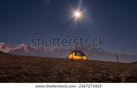 Camping under full moon night during the Brahmatal Trek in Uttarakhand India in winter season