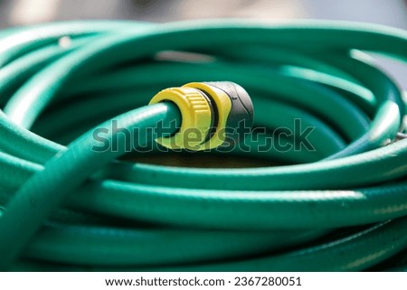 green hose in green grass Royalty-Free Stock Photo #2367280051