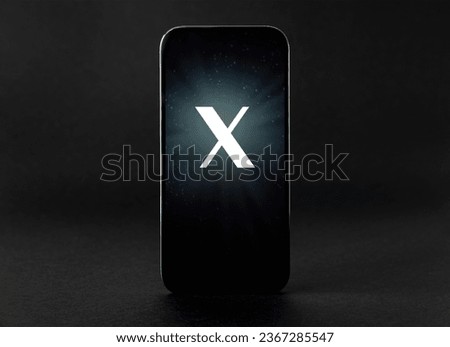Mobile phone with a letter X on the screen Royalty-Free Stock Photo #2367285547