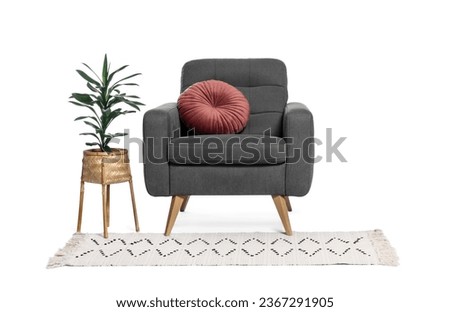 One grey armchair with pillow, houseplant and rug isolated on white Royalty-Free Stock Photo #2367291905