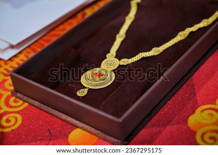 Close up shot of gold jewelry, necklace set, pendent with selective focus. Pure gold 22k jewelry for sale with copy space. Indian real gold pendent set for advertisement. 