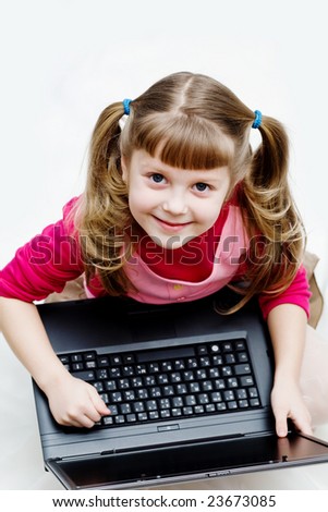 Stock photo: an image of a little girl with laptop