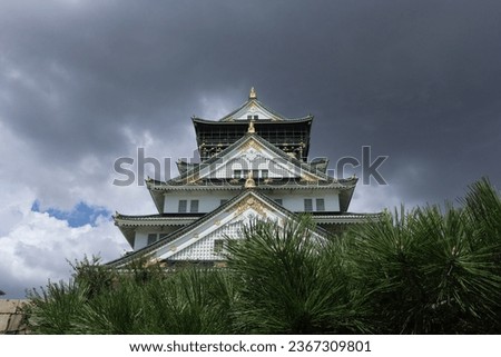 Osaka castle background with bright blue sky and green plants in summer