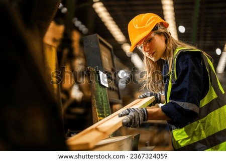 Factory engineer woman standing confident to control panel switch. Worker works at heavy machine at industry factory. worker checking timber of raw wood material. smart industry worker operating. Royalty-Free Stock Photo #2367324059