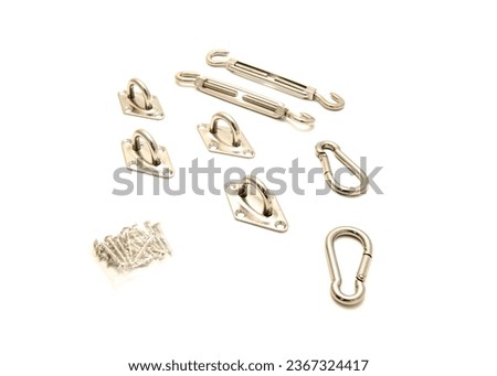 Turnbuckle, pad eye, snap hooks and screws in shade sail hardware kit self-closing locking connector, cable tension, attachment point stainless steel isolated white background. Wire chain heavy duty