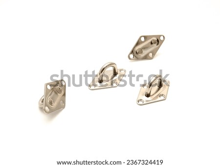 Four pad eyes in sun shade sail hardware kit that a line cable wire chain runs through, provides an attachment point heavy duty stainless steel isolated on white background. Clipping path copy space