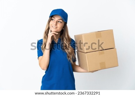 Young Romanian delivery woman isolates on white background thinking an idea while looking up