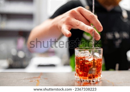 bartender hand making negroni cocktail in bar Royalty-Free Stock Photo #2367338223