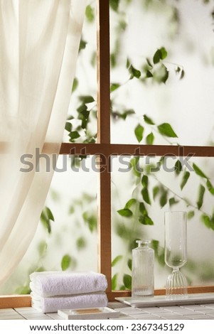 A window view of green leaves in the afternoon sunlight.