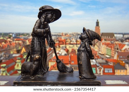 Wroclaw gnomes. Witches Tekla and Martynka (aka Czarownice Tekla i Martynka) on the Penitents Bridge (aka Mostek Pokutnic) between towers of St. Mary Magdalene's Church Royalty-Free Stock Photo #2367354417