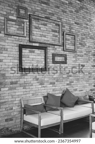 Brick wall hang picture frames and sofa