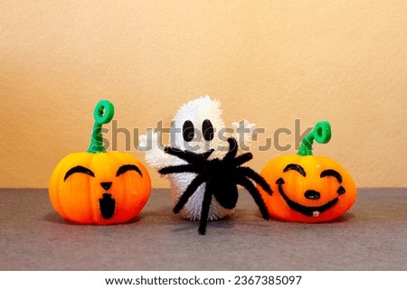 Pumpkins, spiders and ghosts celebrating trick or treat on Halloween day. Smiling orange Jack-O'-Lantern. 