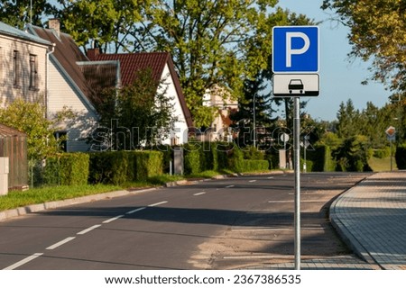 Parking lot sign on the street in residential area. An empty parking lot with no cars and no people.