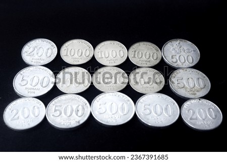 Indonesian Rupiah metal coin, IDR change money, coin made of silver and metal, isolated on black background