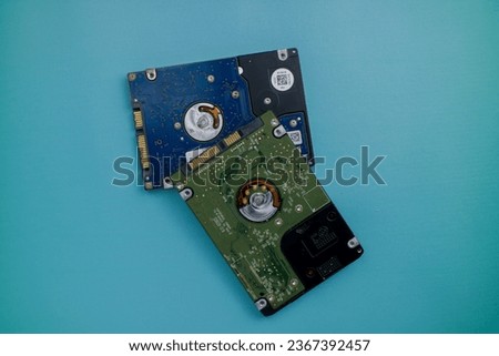 A hard disk is a component in a computer that is useful for storing server data. This photo is on a blue background.