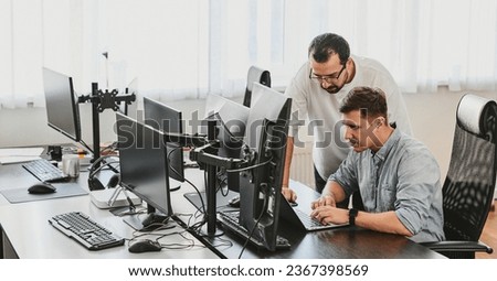 Portrait of two professional male programmers working on computer in diverse offices. Modern IT technologies, development of artificial intelligence, programs, applications and video games concept Royalty-Free Stock Photo #2367398569