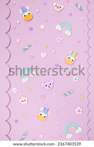 Trendy pastel purple kawaii background with decorative paper borders and cute air plasticine handmade cartoon animals, unicorns, stars, rainbows pattern. Top view, flat lay. Candycore, fairycore.