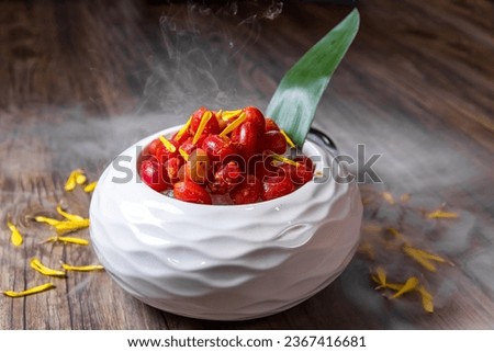 ice smoke chilled red cherry tomato with sour plum flower salad in smoke white bowl appetiser on wood table asian restaurant banquet cuisine halal food menu