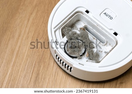 pile of dust and debris in the dust container from the vacuum cleaner, house cleaning robot for Smart home Royalty-Free Stock Photo #2367419131