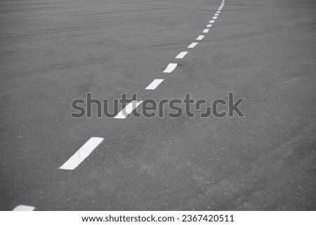 Bike path. Markings on the road. Broken white line on asphalt. Led markings. Royalty-Free Stock Photo #2367420511