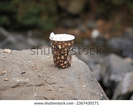 Malang, Indonesia - September 17, 2023: Empty paper coffee cups used for drinking coffee at camping sites