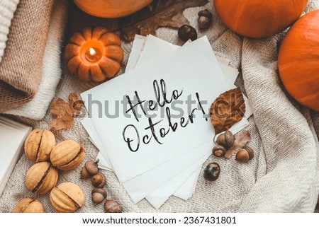 Inscription: hello October on craft paper in autumn decor.