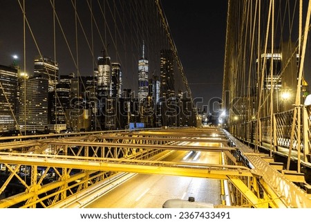 Brooklyn bridge pedestrian walkway at night in New York City, NY, USA