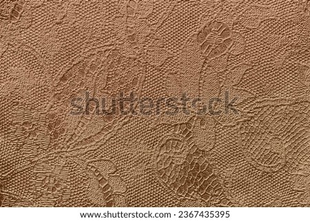 Texture of fragment genuine leather with an abstract floral ornament close-up. Vintage golden bronze background