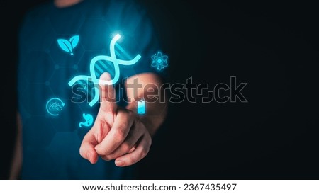 Man hand toching Biotechnology interface icons on isolated black background. Bio technology food, agriculture, environment and medical concept. Biotech symbol theme. Royalty-Free Stock Photo #2367435497