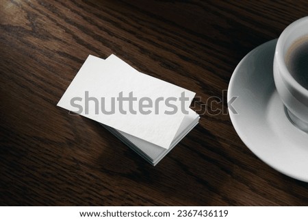 Modern business card mockup template with copy space. Design presentation layouts for corporate identity, advertising, personal, stationery on table with coffee cup. Concept of business.