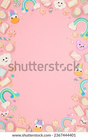 Cute pastel pink kawaii background with frame made of cute air plasticine handmade cartoon animals, unicorns, stars, rainbows. Flat lay, top view, copy space. Beautiful childlike design template